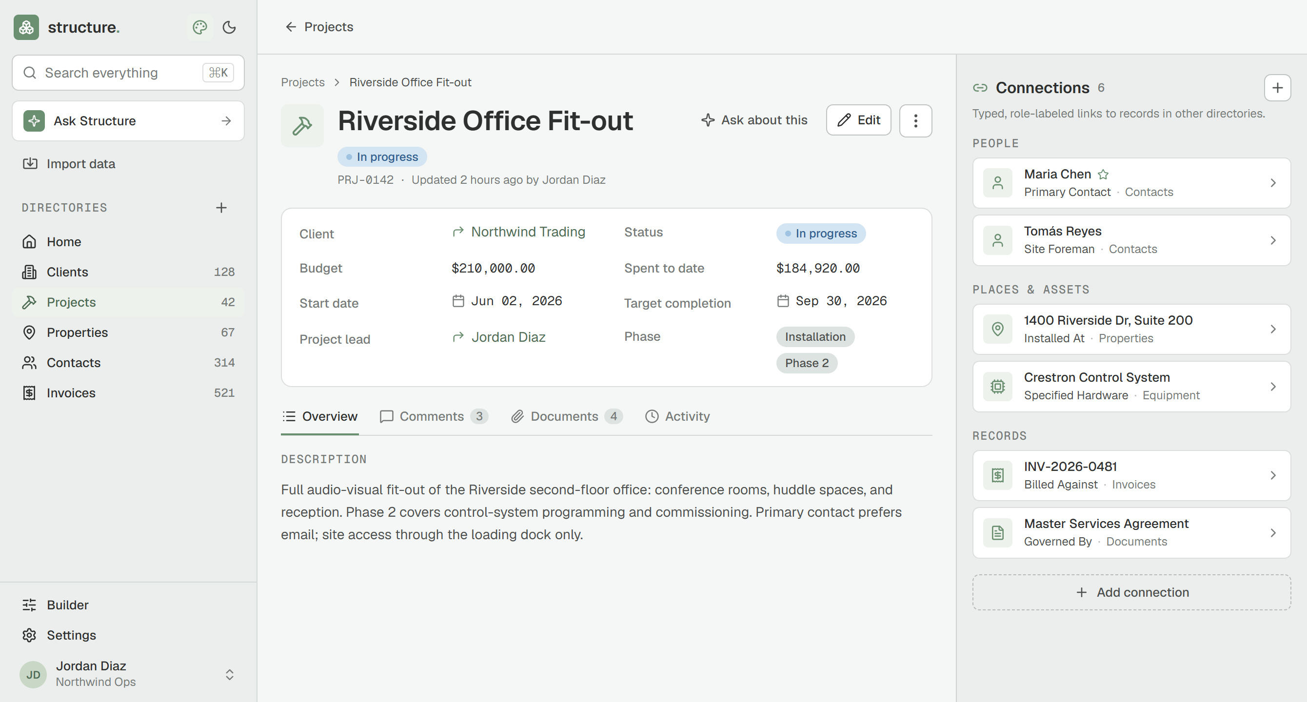 A record open in Structure showing its fields alongside a connections panel -- typed, labeled links to related records in other directories, like the primary contact and the site for a project.